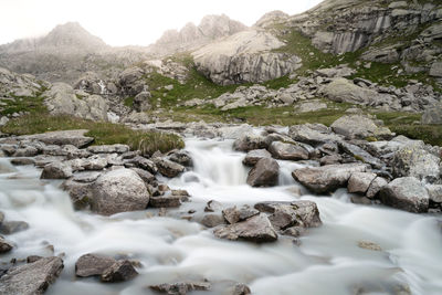 Scenic view of waterfall in mountains