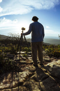 Rear view of woman standing on landscape