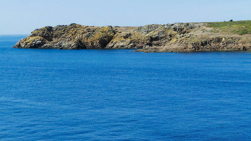 Scenic view of sea against clear blue sky