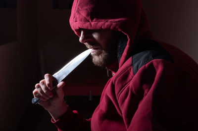 Midsection of man holding umbrella