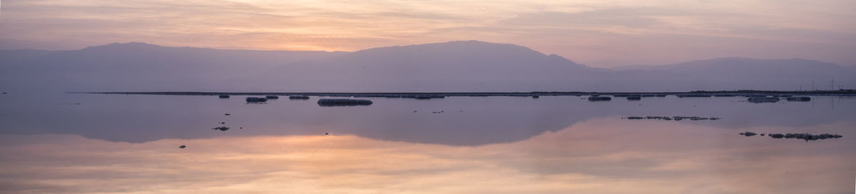 Scenic view of lake against sky during sunset