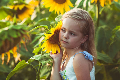 Portrait of cute girl with yellow flower