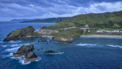 Scenic view of sea and mountains against sky