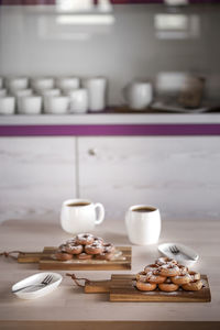 Donuts on cutting boards on table in kitchen