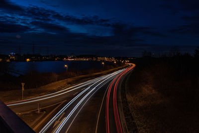 High angle view of light trails on highway at night