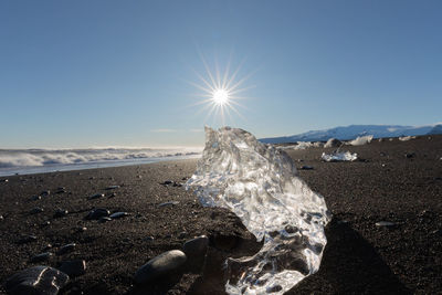 Scenic view of sea against clear sky on sunny day