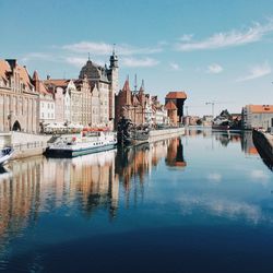 Boats in canal with buildings in background