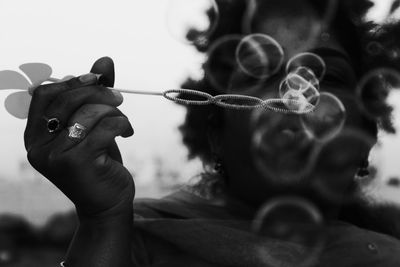 Close-up of woman blowing bubbles