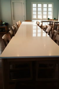 Empty chairs and tables in restaurant