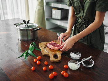 High angle view of chef preparing food on table