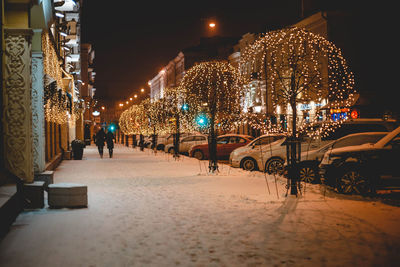 Illuminated christmas lights in city at night