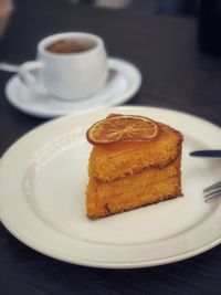 Close-up of cake with coffee on table