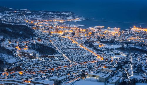 High angle view of illuminated cityscape against sky
