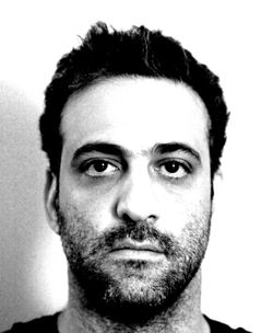 Close-up portrait of young man against white background