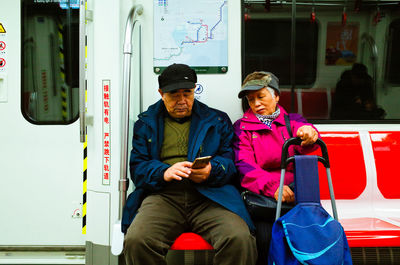 Portrait of friends sitting on train