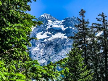 Low angle view of snowcapped mountain against sky