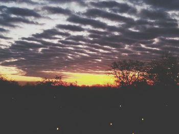 Silhouette of landscape against cloudy sky