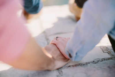 Cropped image of couple holding hands