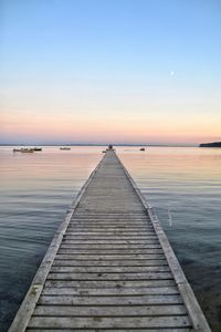 Pier over sea against clear sky