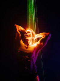 Close-up of woman holding illuminated light