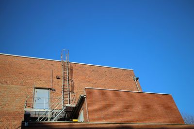 Low angle view of roof against clear blue sky