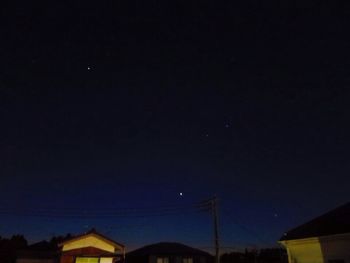 Low angle view of moon against clear sky at night