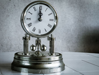 Close-up of clock on table at home