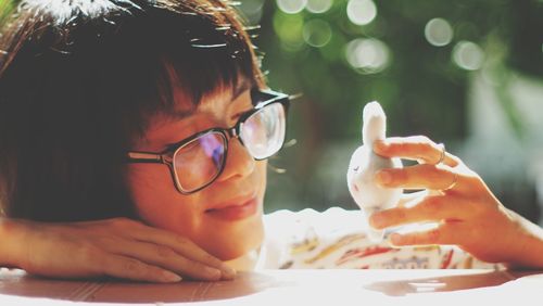 Portrait of girl holding ice cream on table