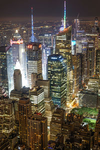 High angle view of illuminated buildings in city at night