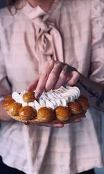 Midsection of woman holding food in plate