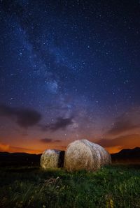 Scenic view of landscape against star field at night