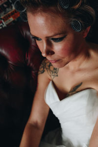Close-up of bride sitting at home