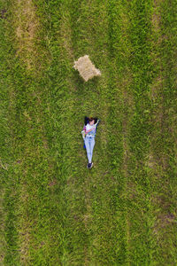 Aerial view of woman lying on field