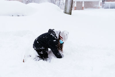 Dogs running on snow covered field
