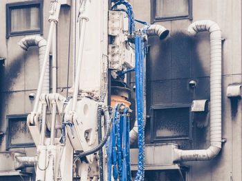 Low angle view of machinery against building