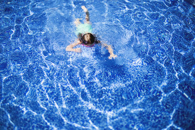 High angle view of girls swimming in pool