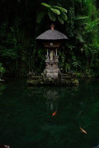 Gazebo in lake against sky
