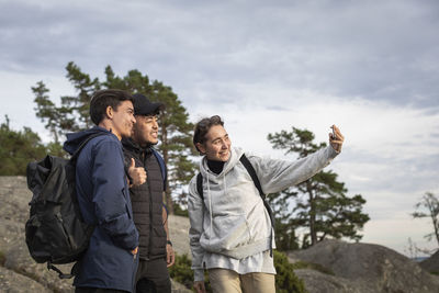 Smiling friends taking selfie