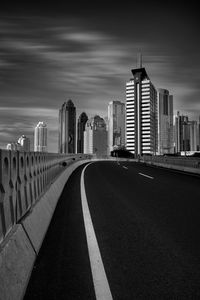 Road amidst buildings against sky in city