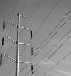 Low angle view of power lines against sky