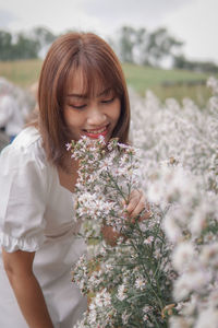 Portrait of young woman holding flowers