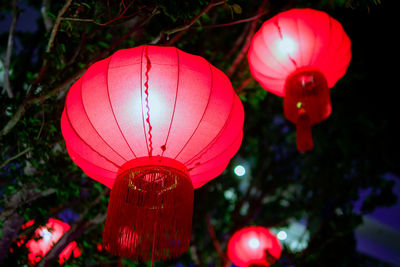 Close-up of illuminated lanterns hanging at night