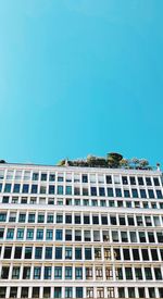 Low angle view of building against clear blue sky