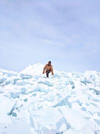 Low angle view of man in snow against sky