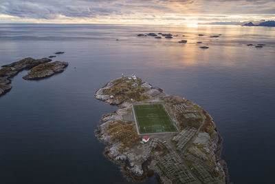 Soccer field on the cliffs of henningsvær by the sea