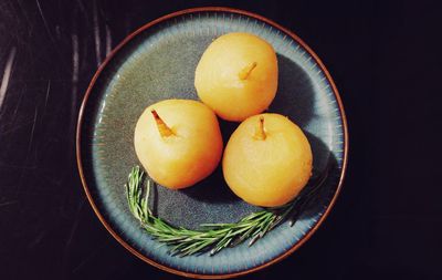 High angle view of orange fruits in basket on table