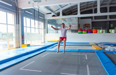 Full length of woman standing by swimming pool