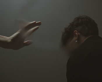 Close-up of hands over white background