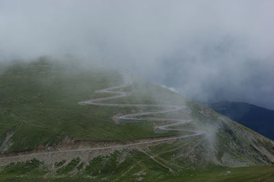 Scenic view of landscape against sky during foggy weather