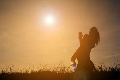 Silhouette man against sky during sunset